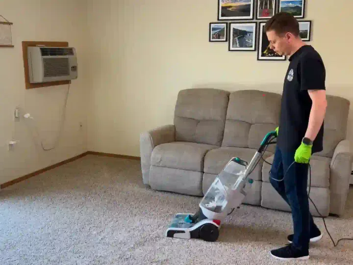 Bliss Carpet Cleaning technician cleaning a carpet in a Las Cruces NM living room
